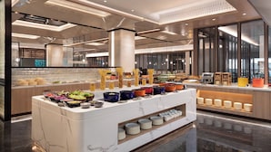 A modern buffet setup with various food stations and a coffee bar, featuring a clean, contemporary design with marble countertops and ample lighting. - Holiday Inn Hotel & Suites Shanghai Changfeng by IHG (Shanghai)