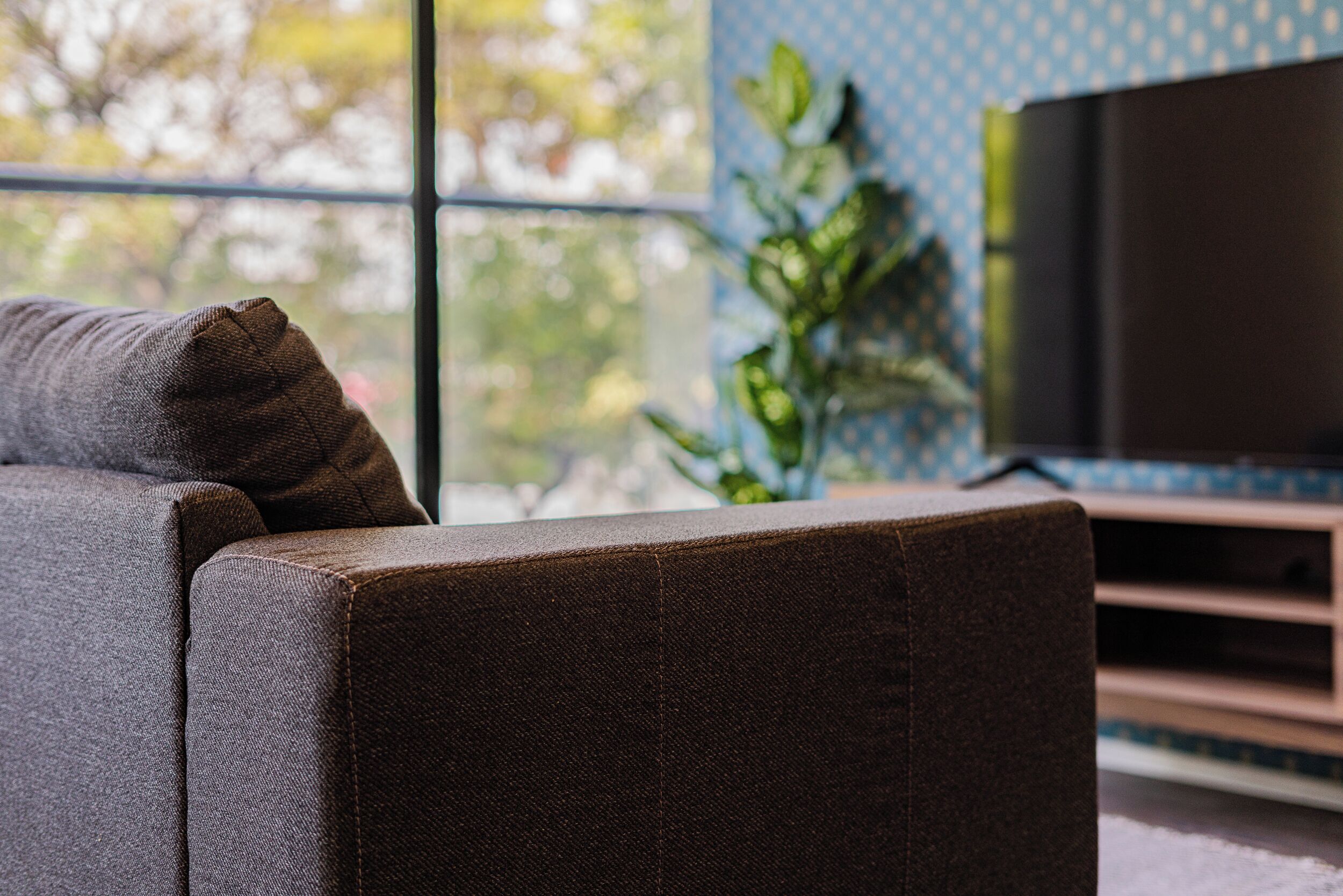 A modern living room with a sofa and a television.
