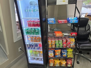 A vending machine with various beverages and snacks, including soda, energy drinks, and chips. - Red Roof Inn Green Brook - Somerset (Green Brook)