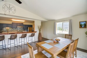 A modern kitchen with dark cabinets, a wooden island, and bar stools. - Hike, Fish, Ski & Explore: Cabin Near Breckenridge (Alma)