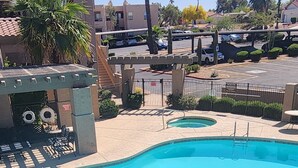 A swimming pool with a deck, a lounge area, and a view of the surrounding buildings. - Charming 2-bedroom condo with WiFi, AC in lovely Fountain Hills (Fountain Hills)