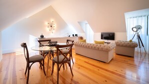 A modern loft apartment with a dining area, sofa set, and a TV. - Once Upon Lisboa (Lisbon)
