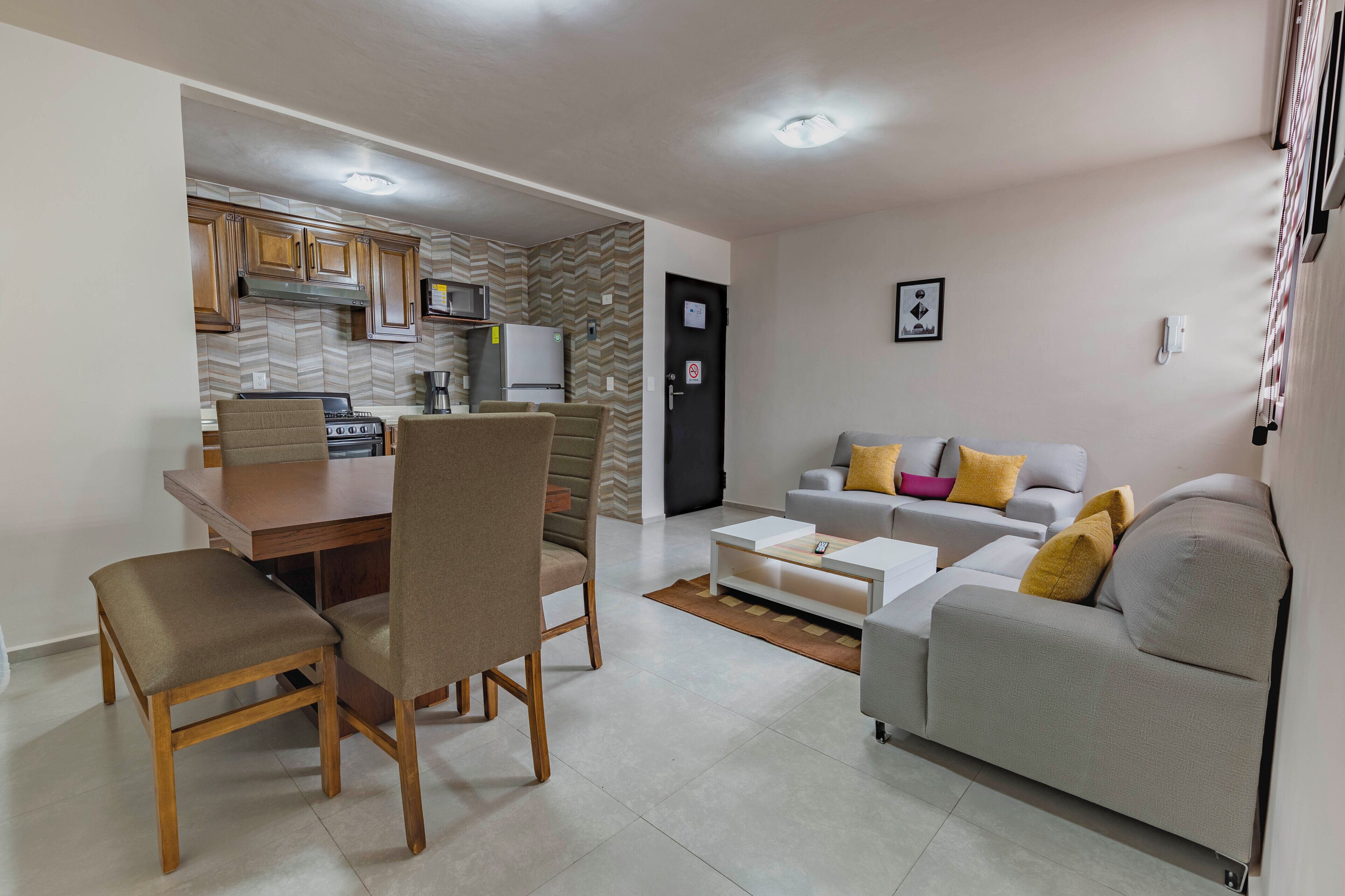 A compact living space with a kitchen, dining area, and seating area.
