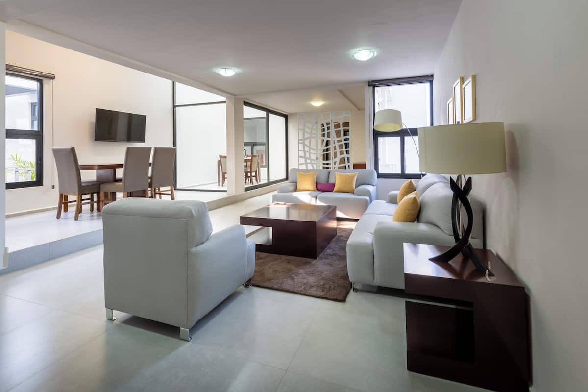 A modern living room with a sofa, coffee table, and TV.