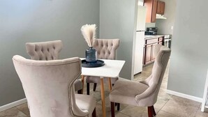 A dining area with a square table and four upholstered chairs. - Cozy 2 Bedroom Home, Dade City! #2 (Dade City)