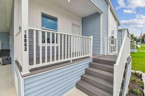 A residential house with a front porch, a mailbox, and a number '10043' on the wall.