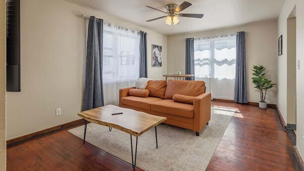 A living room with a sofa, coffee table, and a ceiling fan. - Historical Art Deco Central Downtown - Sleeps 4 (Anchorage)