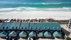 A beachfront hotel with multiple green-roofed buildings, a sandy beach, and the ocean in the background. - Gulfs Edge Townhome #7- Sun-kissed Memories (Panama City Beach)
