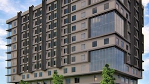 Un immeuble à plusieurs étages doté d’une architecture moderne, caractérisé par une façade composée d’une grille de fenêtres et de balcons.