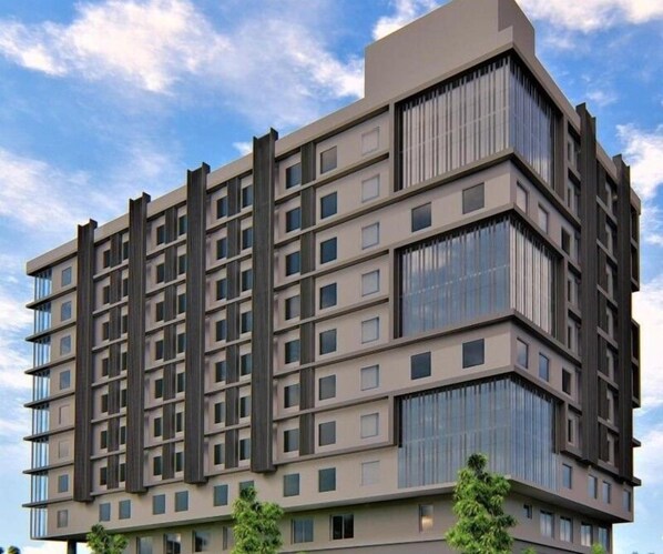 A multi-story building with a modern architectural design, featuring a grid of windows and balconies. - Hotel Deccan Serai Grande (Hyderabad)