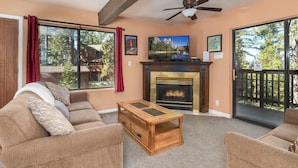 A living room with a fireplace, large windows, and a ceiling fan. - Yosemite Aviary and Quail Within Yosemite - 2 Separate Units, Up To 14 Guests! (Yosemite National Park)