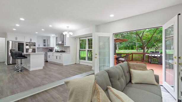 A modern kitchen with white cabinets, a stainless steel refrigerator, and a bar area. - Modern and Spacious 4-bedroom house close to DC and National Harbor (Fort Washington)