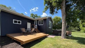 A house with a deck, a door, and a window.