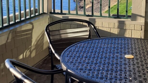 A covered patio with a view of a lake and a house. - FIREWORKS, LAKE ACCESS, BOAT MOORING OPTION - 3-bedroom unit Lake Coeur d'Alene (Harrison)