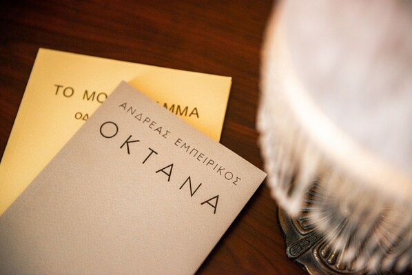 A book titled "OKTANA" on a wooden surface.