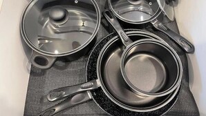 A kitchen drawer with stainless steel cookware, including pots and pans, and a black silicone mat. - Superb Chambray 4 Beds, 2 Baths in Moreno Valley, CA. (Moreno Valley)