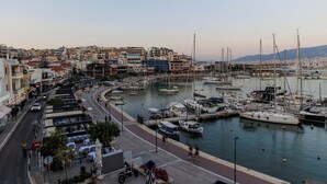 A marina with boats docked, a street with shops and restaurants, and buildings in the background. - Seaside Grey Pearl Villa 
Sea Views, Ideal for Artists & Dreamers (Pireas)