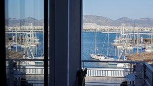A marina with multiple sailboats docked, a clear sky, and mountains in the background. - Seaside Grey Pearl Villa 
Sea Views, Ideal for Artists & Dreamers (Pireas)