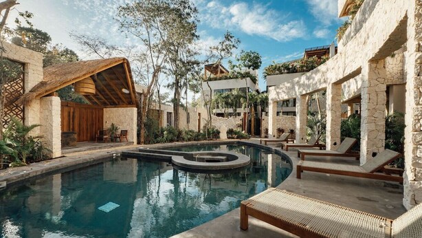 A pool area with lounge chairs and a stone building. - 1BR Hidden Gem–Priv Pool+Garden at Launch Price (Tulum)