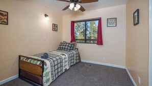 A bedroom with a bed, a ceiling fan, a window with curtains, and wall-mounted lights. - Yosemite Aviary - Bird's Eye View! Awesome Upper Unit! (Yosemite National Park)