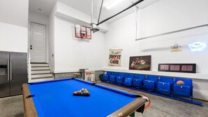 A pool table with balls, a projector, and a digital scoreboard in a room with blue chairs and a refrigerator. - 19 Bed Downtown Rooftop Gameroom Walk To Broadway (Nashville)
