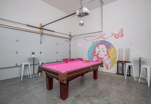 A billiards room with a pool table, chairs, and a mural on the wall. - 21 Bed Downtown Luxury Bachelorette w Rooftop (Nashville)