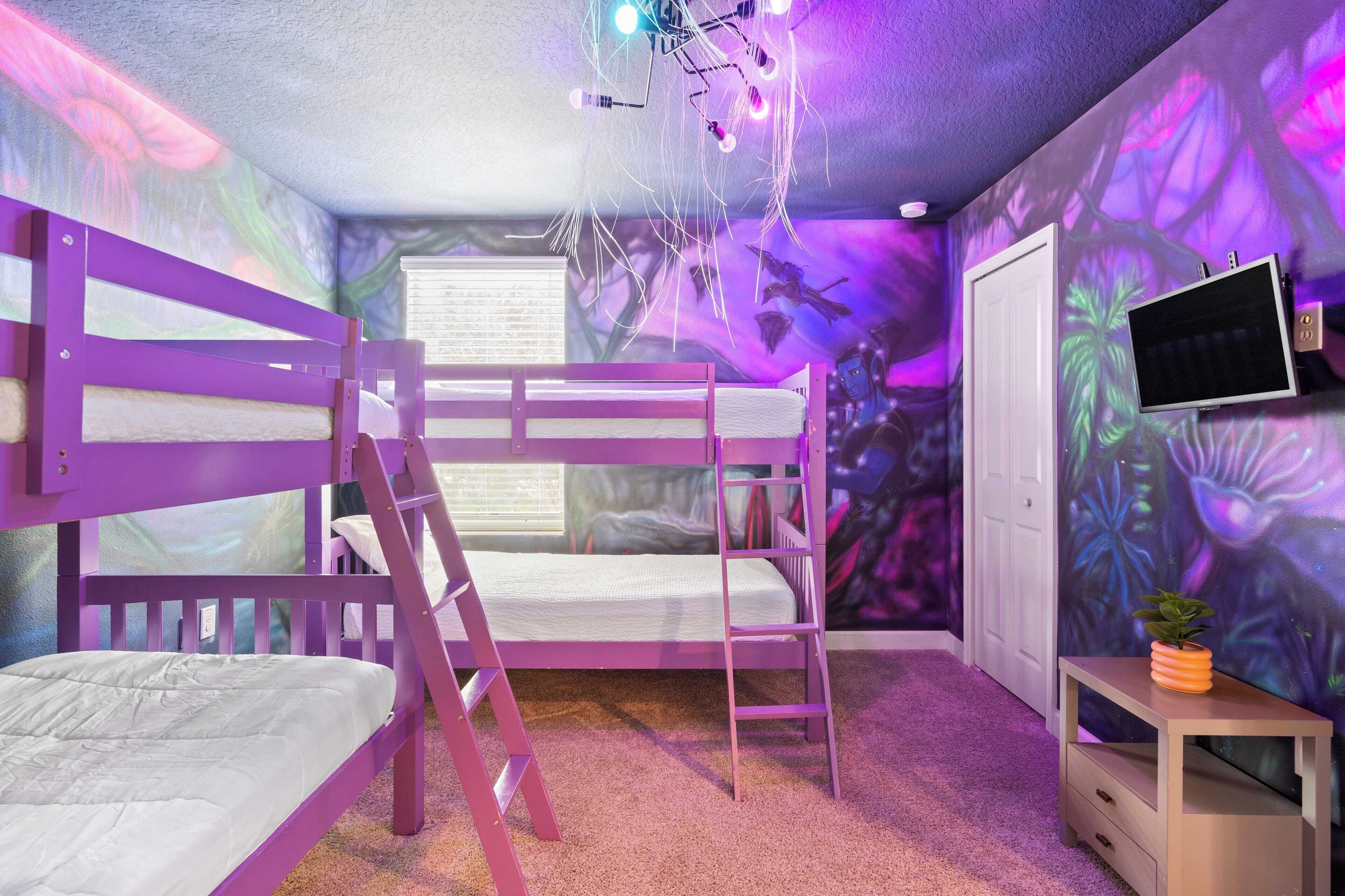 A bedroom with bunk beds, a TV, a small table with a plant, and a wall mural.