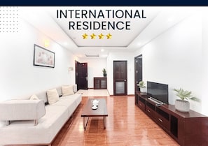 Family Apartment, 2 Bedrooms, Balcony, City View | In-room safe, desk, laptop workspace, iron/ironing board