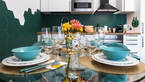 A modern kitchen with white cabinets, a stainless steel oven, and a green backsplash. - CASA FEN historic building - King of Rome MetroA 2 bedrooms 2 bathrooms (Unknown)