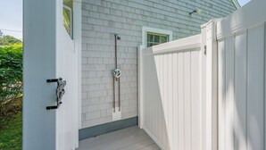 A white exterior wall with a window and a door.