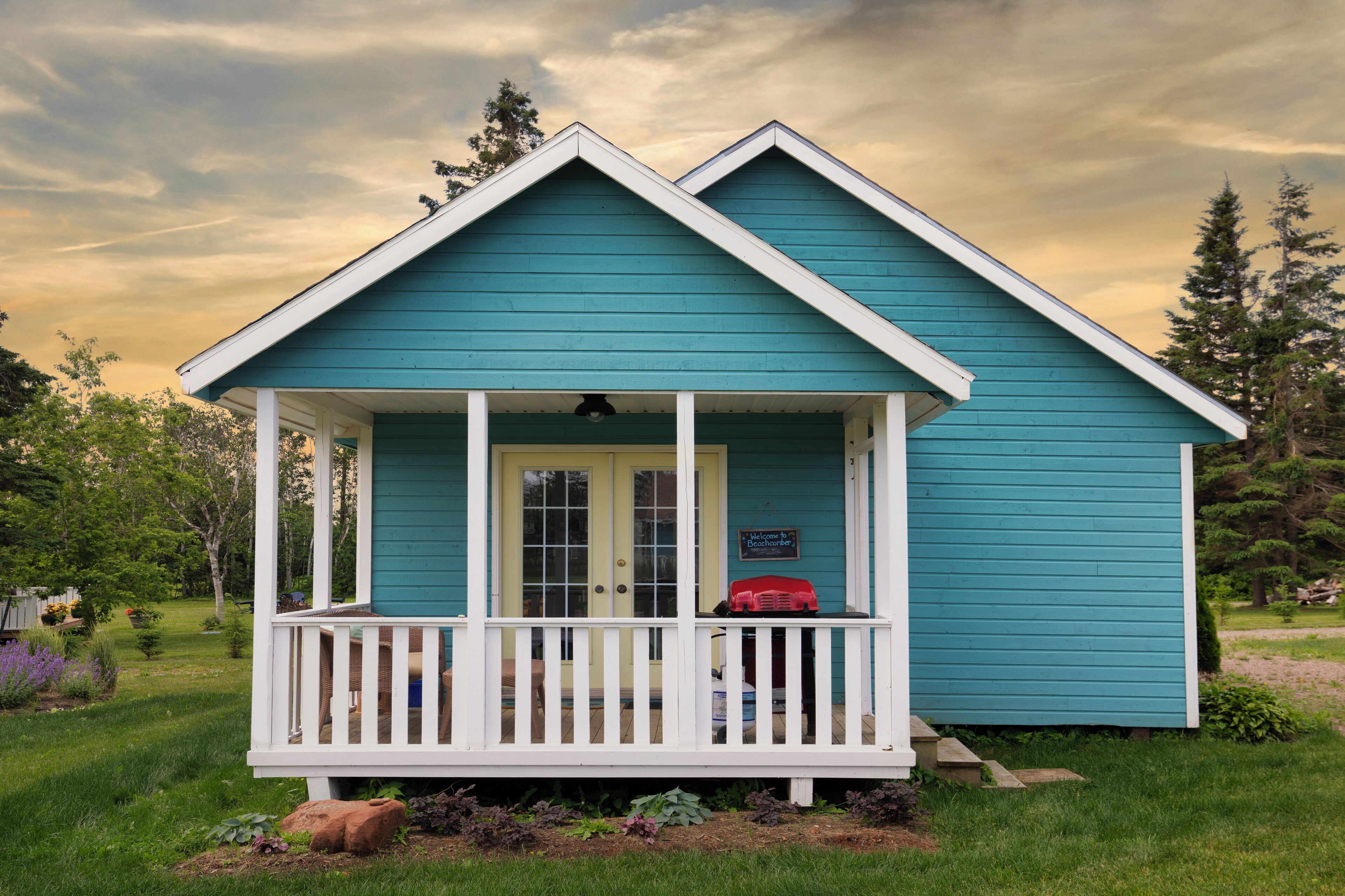 A small, single-story house with a porch and a door.