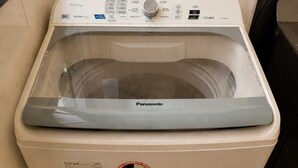 A front-loading washing machine with a control panel, energy efficiency label, and a Panasonic brand logo. - Feel at Home in Belém – Cozy & Fully Equipped Apartment in Guamá (Guamá, Belém)