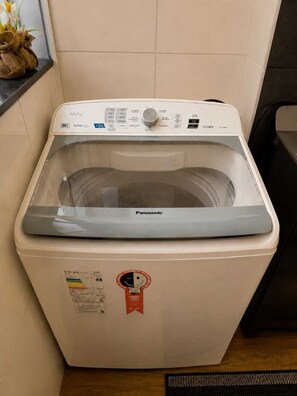 A front-loading washing machine with a control panel, energy efficiency label, and a Panasonic brand logo.