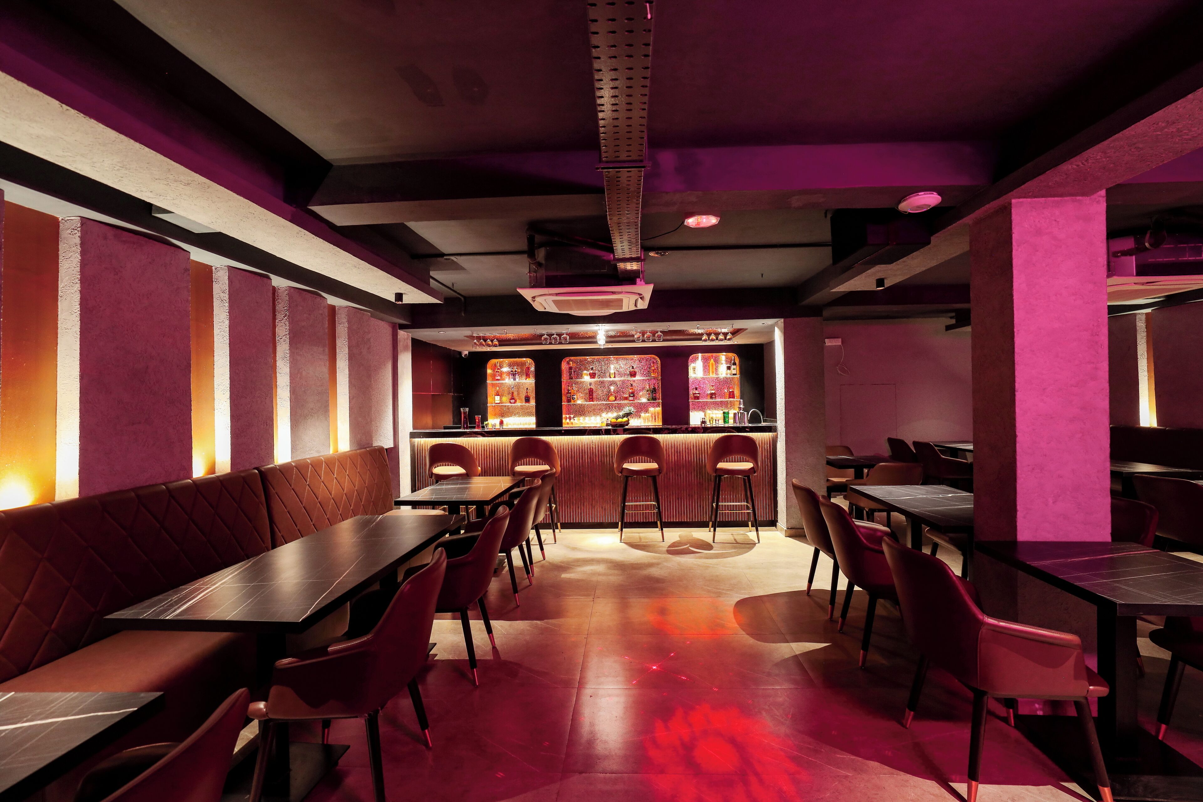 Un ristorante con banconi e tavoli, un'area bar e un arredamento moderno.