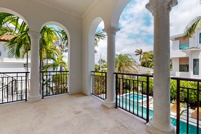 Ocean view estate w/ in ground outdoor pool, breezy terraces, and covered lanai