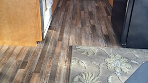 A kitchen with wooden cabinets, a microwave, a stove, and a refrigerator. -    Cozy cottage for vacation in Cedar Ridge near its famous trail. (Sonora)
