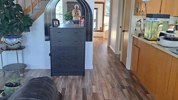 A spacious kitchen with wooden cabinets, a black countertop, and a fish tank. -    Cozy cottage for vacation in Cedar Ridge near its famous trail. (Sonora)