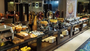 A buffet with various food items and a self-service beverage station.