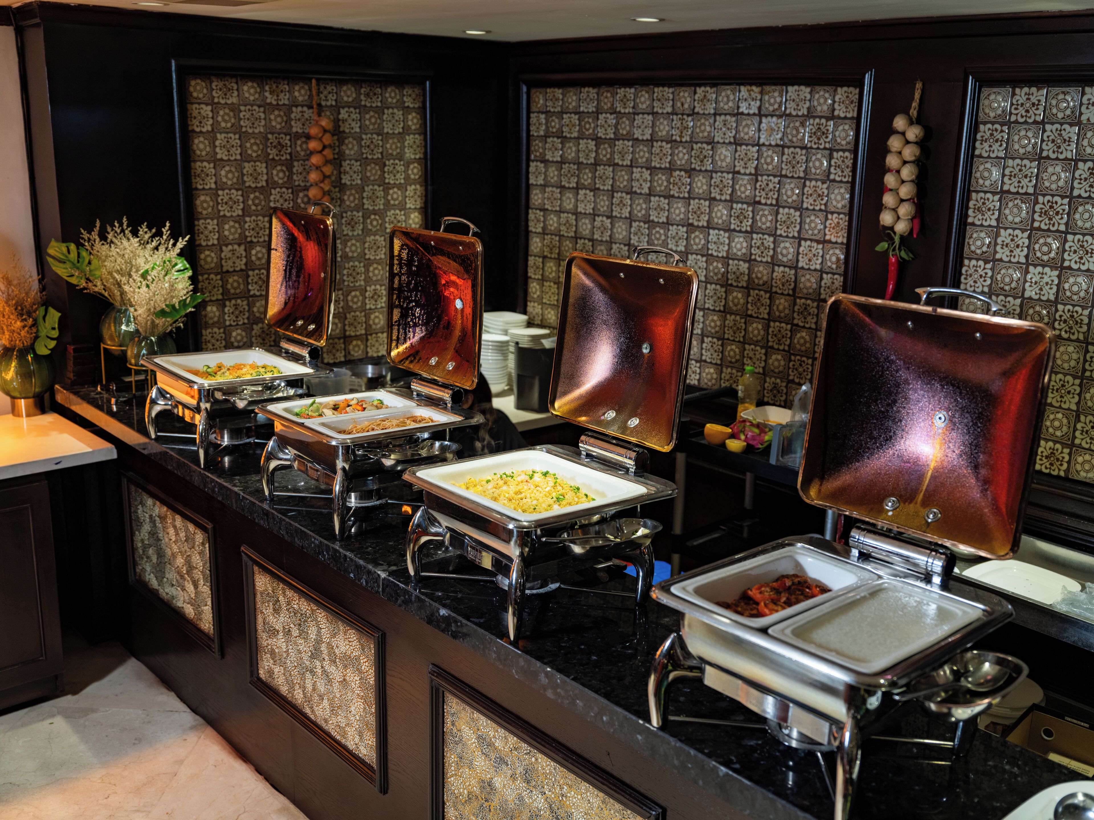 A buffet setup with multiple self-service stations, each with a variety of dishes.