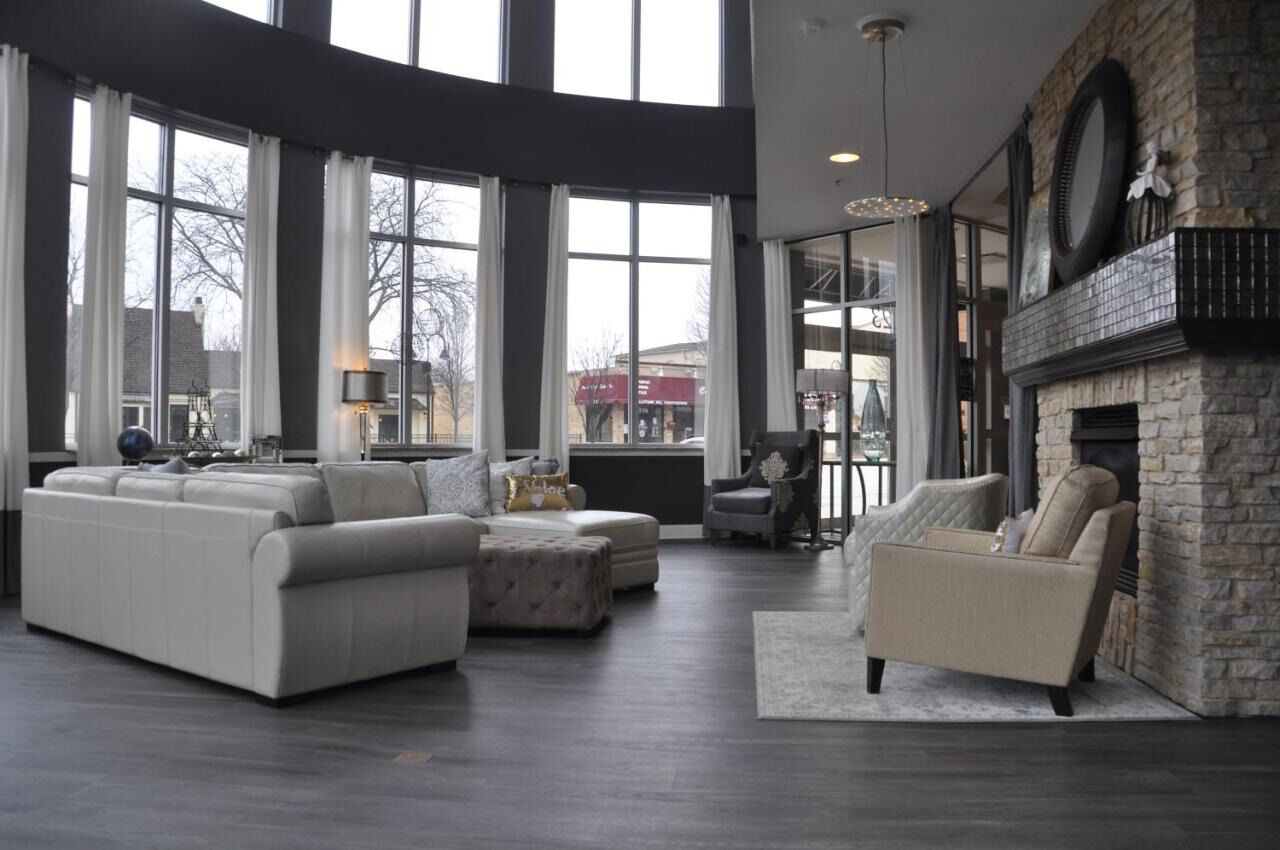 Unwind in the sunlit lounge beside the cozy stone fireplace.