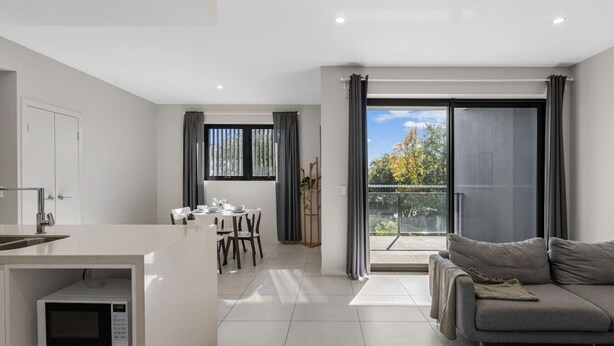 A modern apartment with a kitchen, dining area, and living room. - 2BR Apartment w/ Balcony Near Food Shop & Transit (Macgregor)