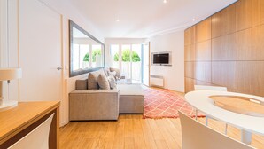 A modern bathroom with a wooden vanity, a large mirror, and a seating area with a sofa. - Indigo Blue • Air conditioning - Swimming pool - Parking - Calm (La Garde-Freinet)