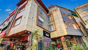 A modern hotel with a prominent 'VIAAN HOTEL' sign, a glass facade, and a corner location with visible storefronts. - Deluxe Hotel Vihaan Residency (Dera Bassi)