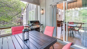 A covered patio with a table and chairs, a grill, and a view of the outdoors. - Steps to Jack Frost Ski Resort: Townhome w/ Decks (Lake Harmony)
