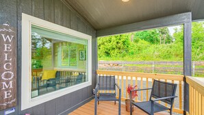 A wooden deck with a "WELCOME" sign, a glass door, and two chairs. - 11 Mi to Port Townsend Ferry: Cottage w/ View! (Port Hadlock-Irondale)