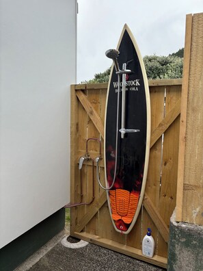 Property grounds - Watch the waves from the large, sunny deck of this 1950's bach. Pet friendly. (Ahipara)