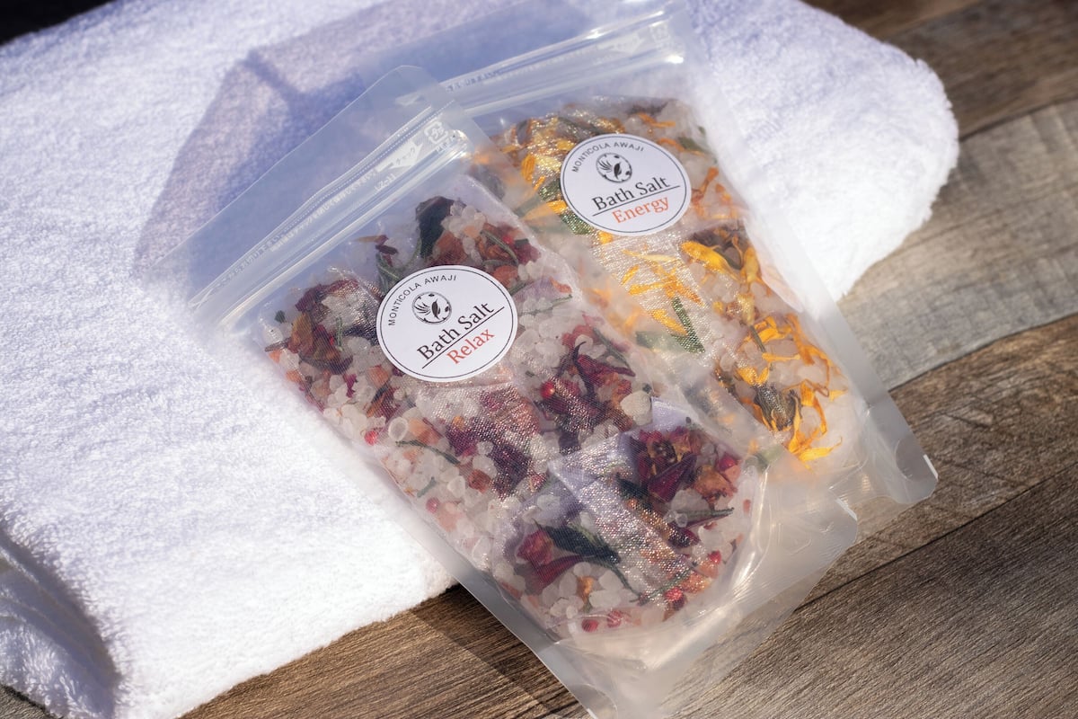 Two plastic bags labeled 'Bath Salt Energy Relax' on a wooden surface.
