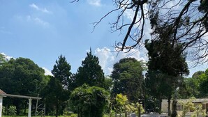 A park with a gazebo, benches, and a grassy area. - BADAI HERITAGE VILLA KALIURANG (Pakem)