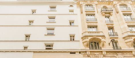 A multi-story building with a classical architectural style, featuring ornate balconies and large windows.