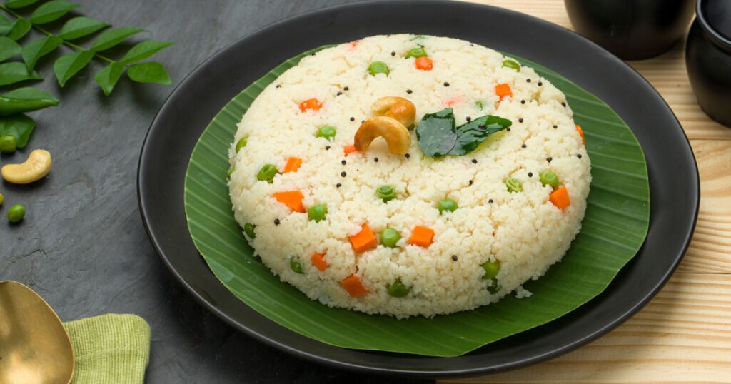 A plate of rice with vegetables and a bay leaf on a banana leaf.